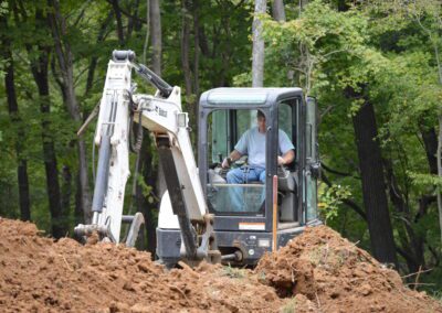 Bobcat machine is working on the path clearing -front view